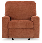 Rocker recliner chair in rust-orange upholstered fabric with centered seat cushion and arms.