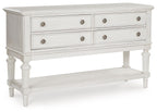 Montelaine antique white dining room server with two drawers, two doors, and turned legs