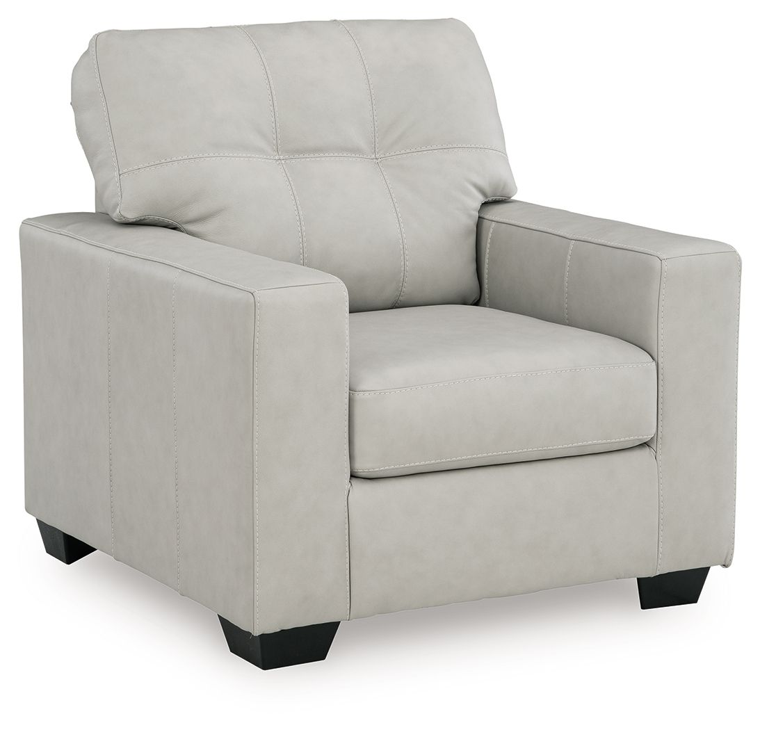 Light beige upholstered accent chair with tufted back and padded armrests