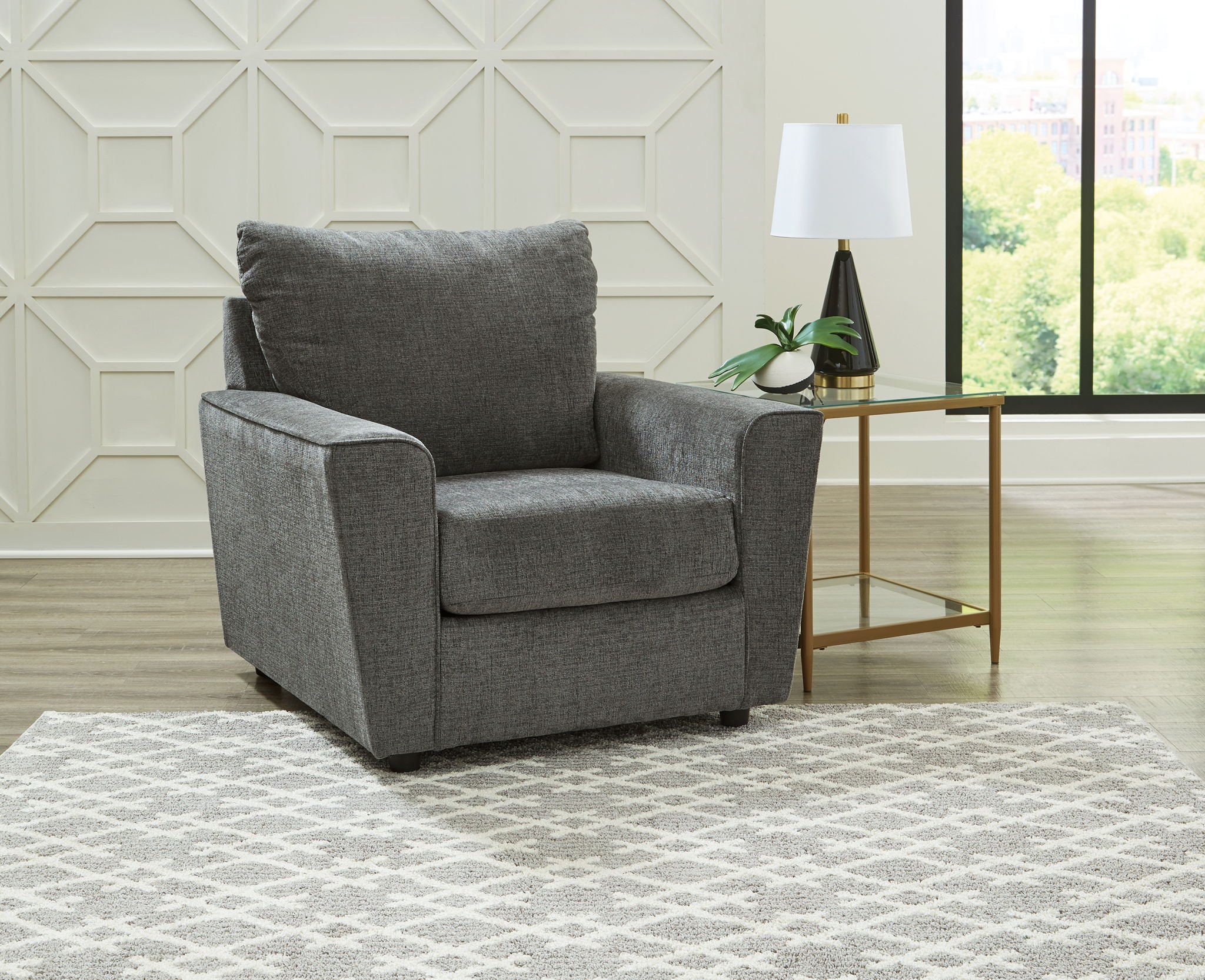 Dark gray fabric armchair with rolled arms, one seat cushion, and two back pillows.