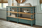Blue console sofa table with two shelves and two drawers, styled with tabletop decor