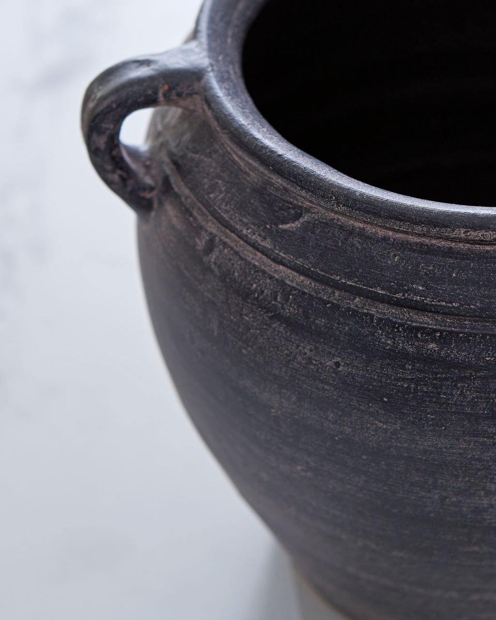 Meadie 9-inch vase, dark blue ceramic close-up with textured surface and handle