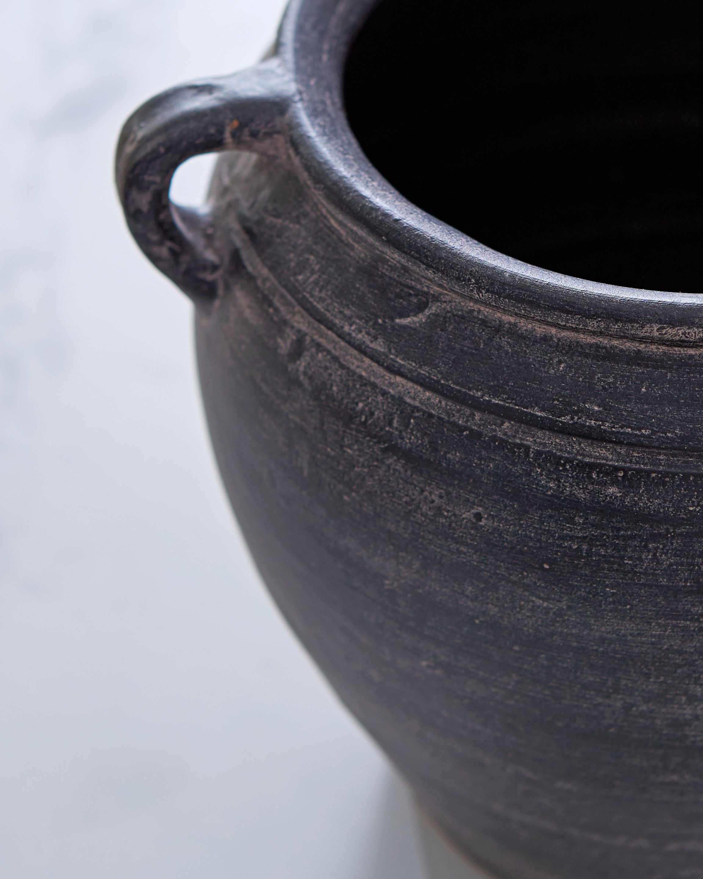 Meadie 9-inch vase, dark blue ceramic close-up with textured surface and handle