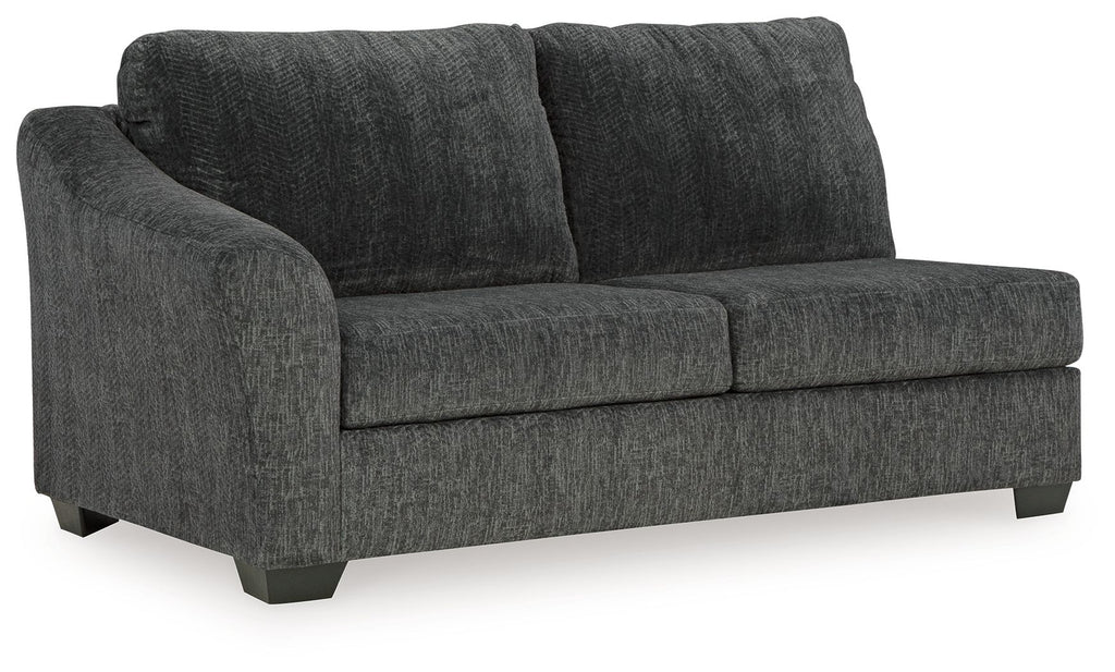 Dark gray upholstered sofa with boxy arms, two seat cushions and tall back.