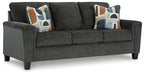 Dark gray sofa with three seat cushions and patterned throw pillows