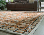 Geometric patterned area rug in brown, tan, and gray with flat woven texture.