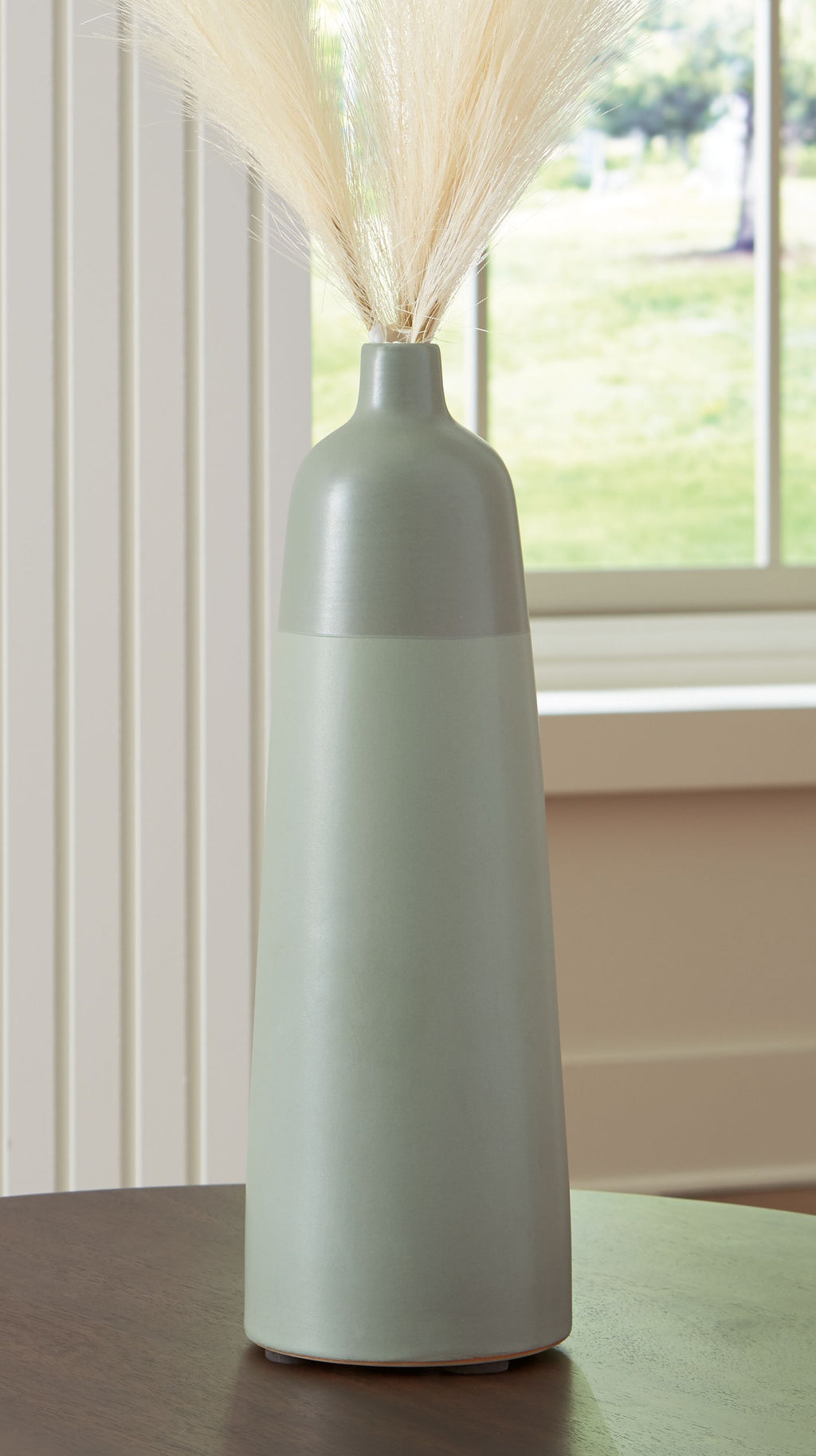 Sage green ceramic vase with tall slim form and flared top rim