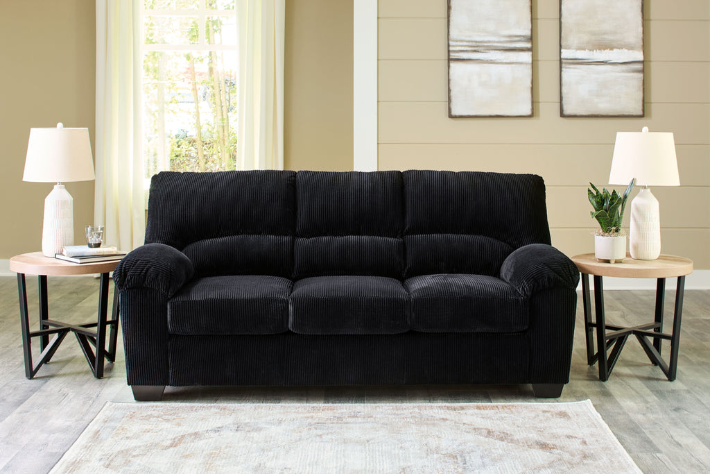Charcoal black corduroy sofa with tufted back and rolled armrests