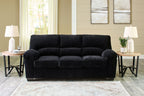 Charcoal black corduroy sofa with tufted back and rolled armrests