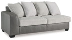 Grey upholstered sofa with ribbed front cushions and two light throw pillows
