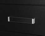 Black six-drawer dresser with silver bar pull detail on upper drawer.