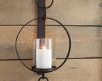 Brown wall sconce with circular metal ring and white glass cylinder light