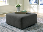 Oversized accent ottoman in dark gray textured fabric with short legs
