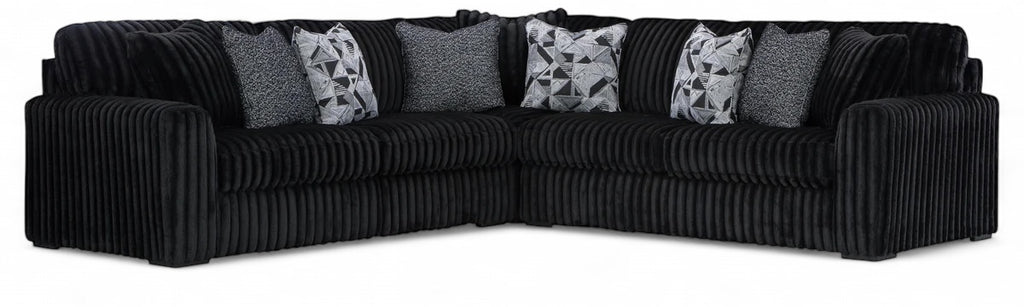 Sectional sofa with tufted arms, black corded upholstery and gray accent cushions