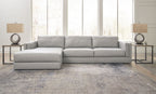 Sectional sofa with chaise lounge, light gray upholstery, centered back cushions and square arms