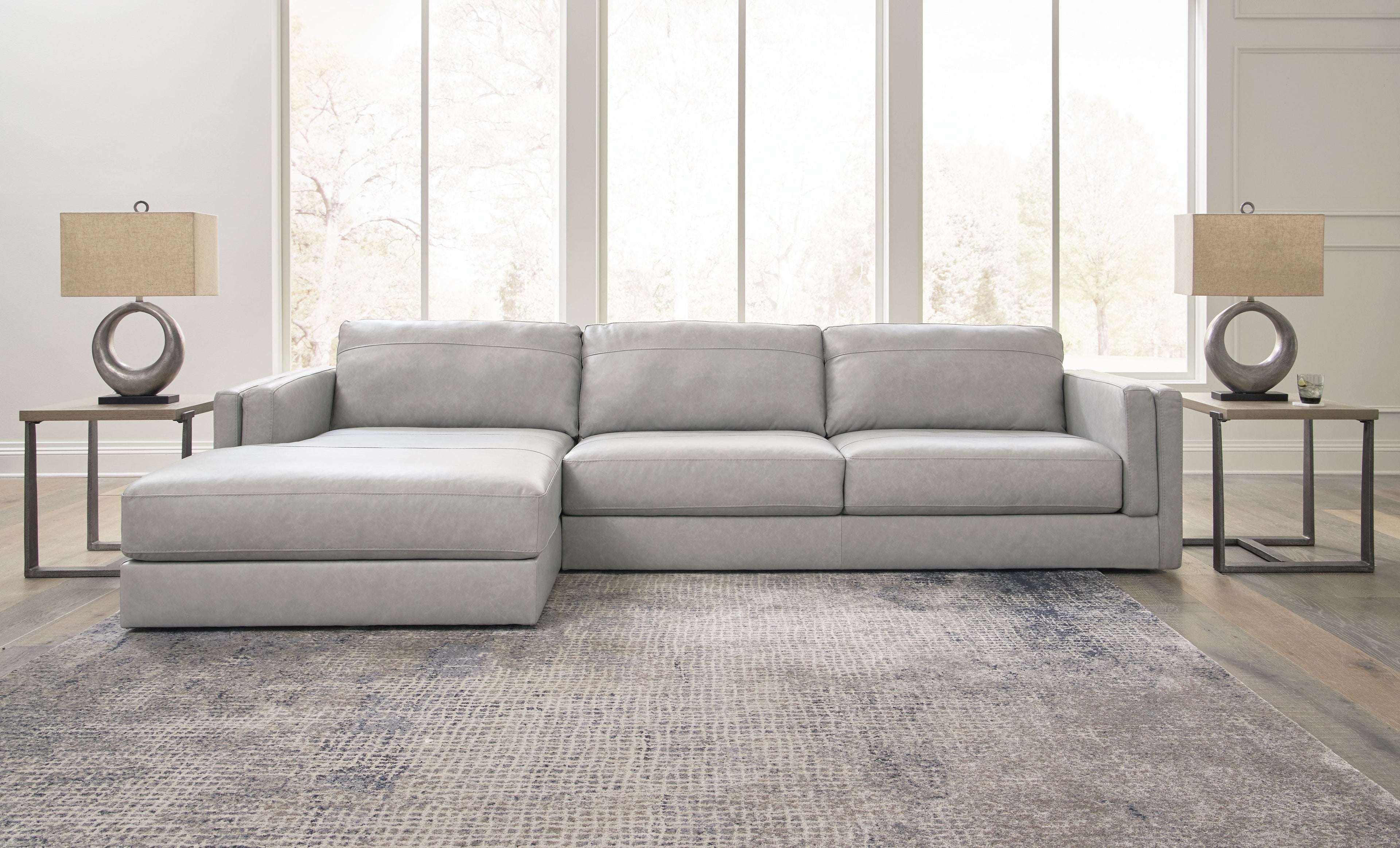 Sectional sofa with chaise lounge, light gray upholstery, centered back cushions and square arms