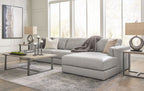 Sectional sofa with chaise lounge, light gray upholstery, rounded seat edges and back pillows