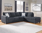 Dark gray L-shaped sectional sofa with chaise, back cushions and decorative pillows