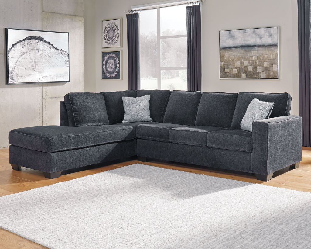 Dark slate corner sectional sofa with chaise and light throw pillows