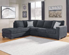Dark slate corner sectional sofa with chaise and light throw pillows