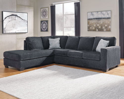 Dark slate corner sectional sofa with chaise and light throw pillows