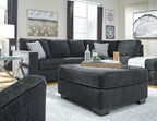 Dark slate sectional sofa with chaise and multiple throw pillows