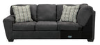 Slate sectional sofa with two patterned square pillows and wide cushioned arms