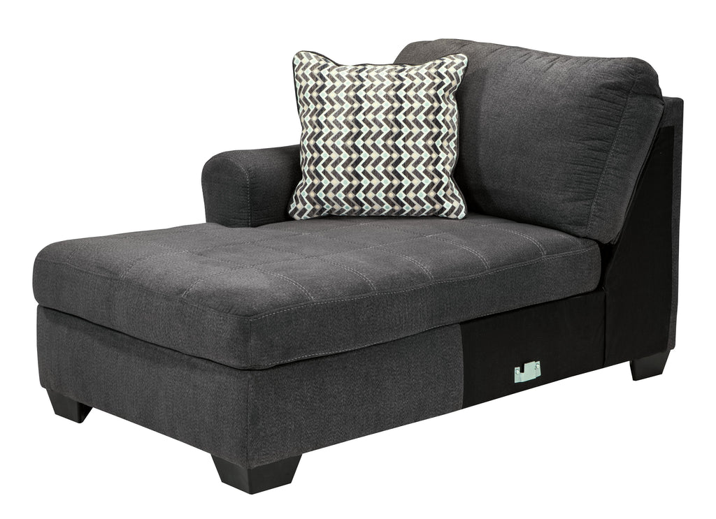 Slate chaise lounge section with one patterned throw pillow and square armrest