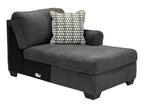 Slate chaise lounge section with one patterned pillow and rectangular seat cushion
