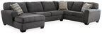 Slate sectional sofa with chaise, tufted cushions, and two black-and-white throw pillows