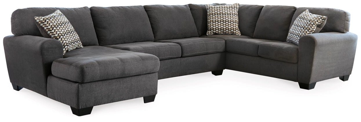 Slate sectional sofa with chaise, tufted cushions, and two black-and-white throw pillows