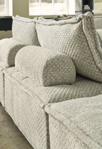 Textured fabric sectional sofa with chaise and matching seat cushions, light taupe color