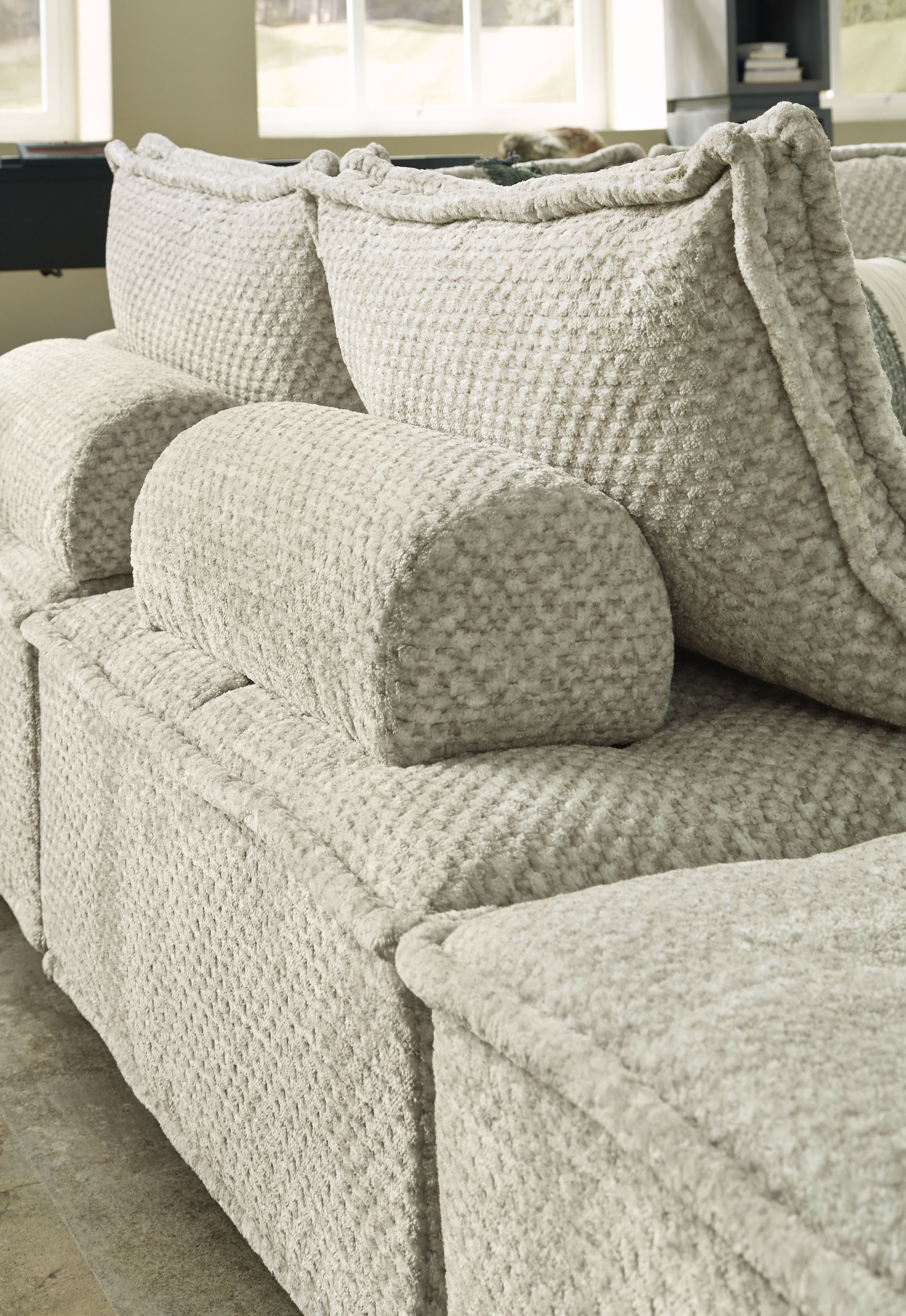 Textured fabric sectional sofa with chaise and matching seat cushions, light taupe color