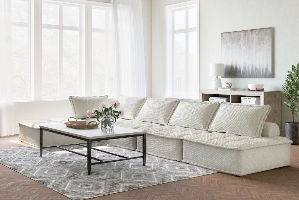 Light taupe sectional sofa with long chaise and square cushions, textured fabric