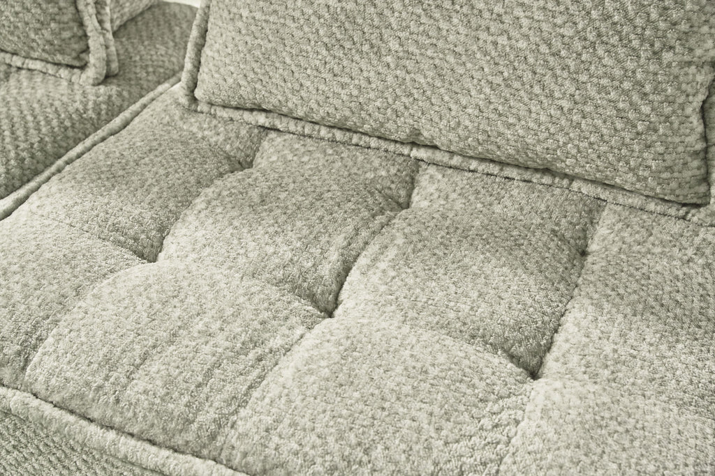 Close-up of taupe sectional seat cushions with textured fabric and stitched edges