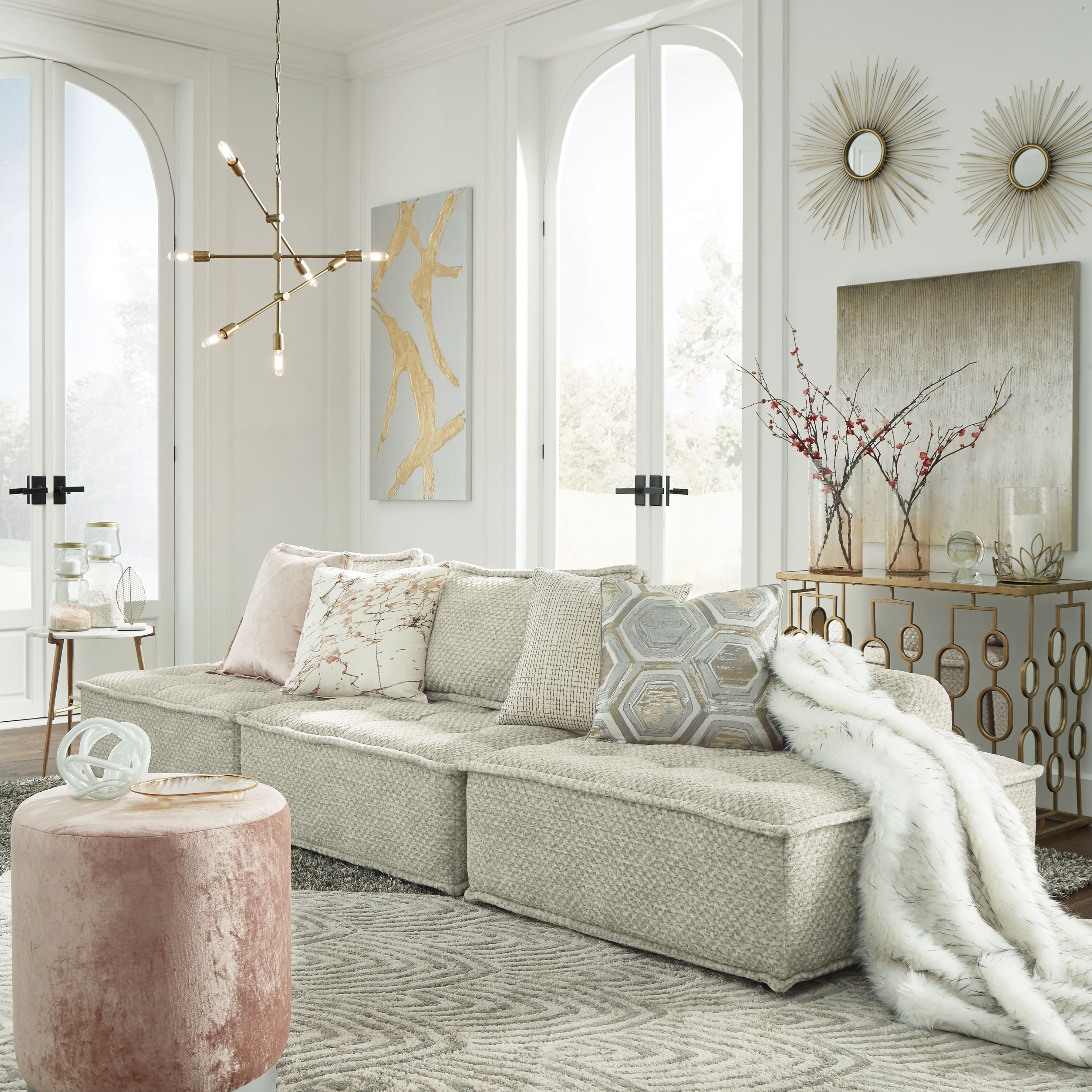 Light taupe modular sectional sofa with chaise, layered cushions, and textured upholstery