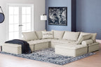 Taupe modular sectional with multiple seats and back pillows, styled with a chaise section