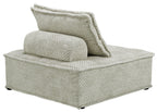 Taupe upholstered chaise lounge with curved arm and back pillow, angled view