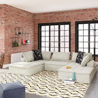 Taupe modular sectional sofa with chaise sections and decorative throw pillows