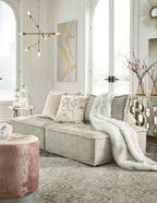 Taupe modular sectional sofa with wide chaise and layered accent pillows