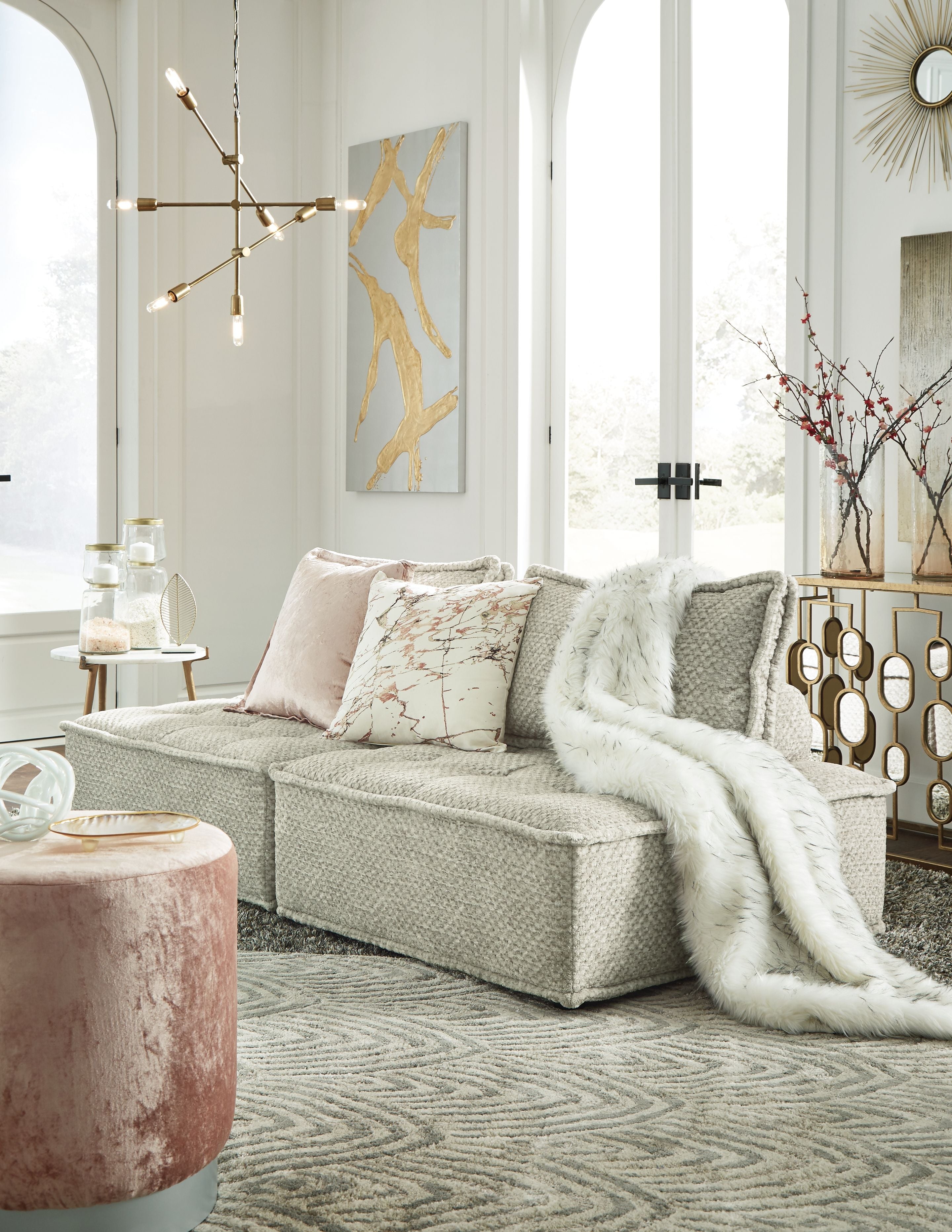 Taupe modular sectional sofa with wide chaise and layered accent pillows