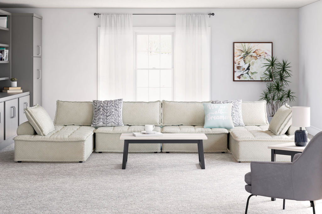 Taupe modular sectional sofa with long chaise and square throw pillows