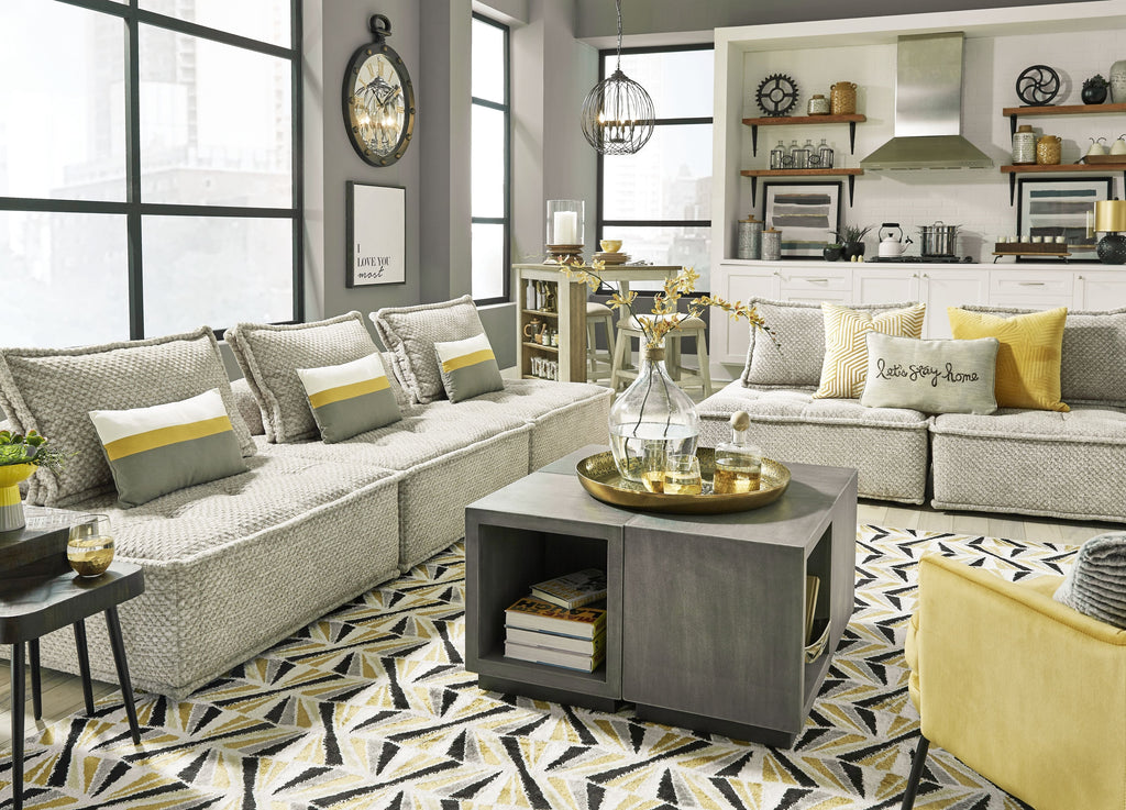 Taupe fabric modular sectional sofa with tufted cushions and multiple throw pillows