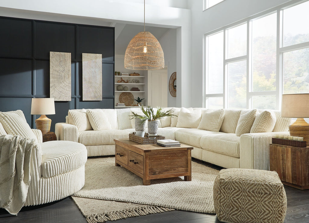 Ivory 5-piece sectional sofa with ribbed corduroy cushions and decorative throw pillows