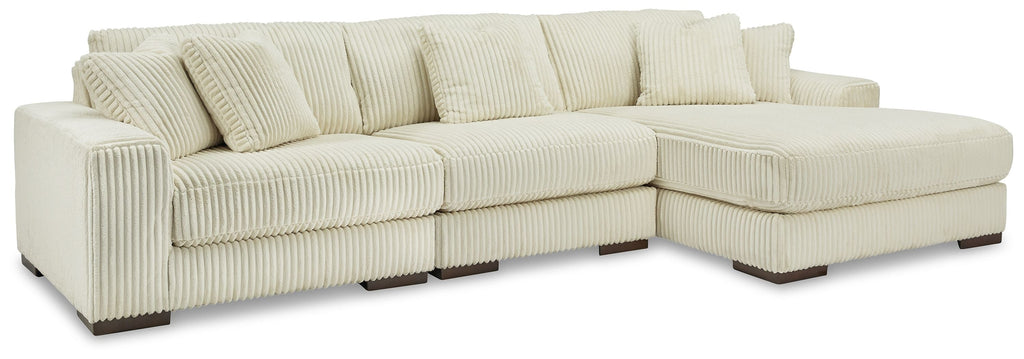 Ivory sectional sofa with chaise corner, ribbed corduroy-like upholstery, and boxy arms.