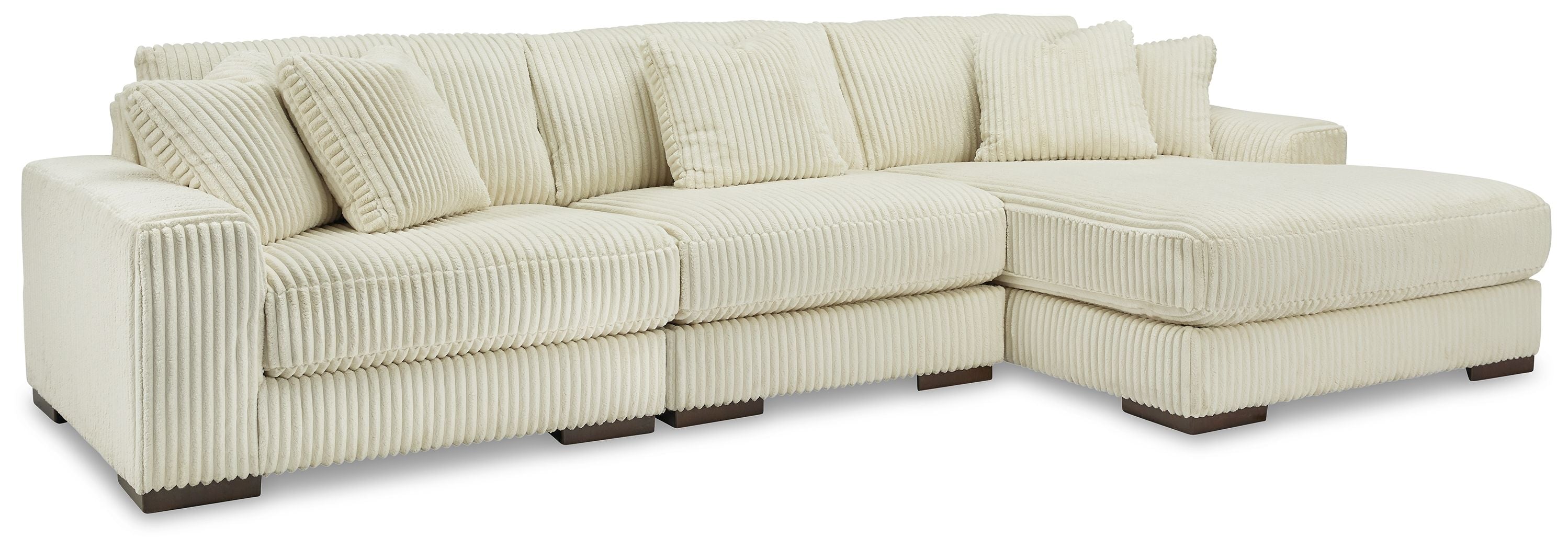 Ivory sectional sofa with chaise corner, ribbed corduroy-like upholstery, and boxy arms.