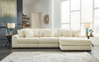 Ivory sectional sofa with chaise and tufted back cushions, in ribbed textured fabric.