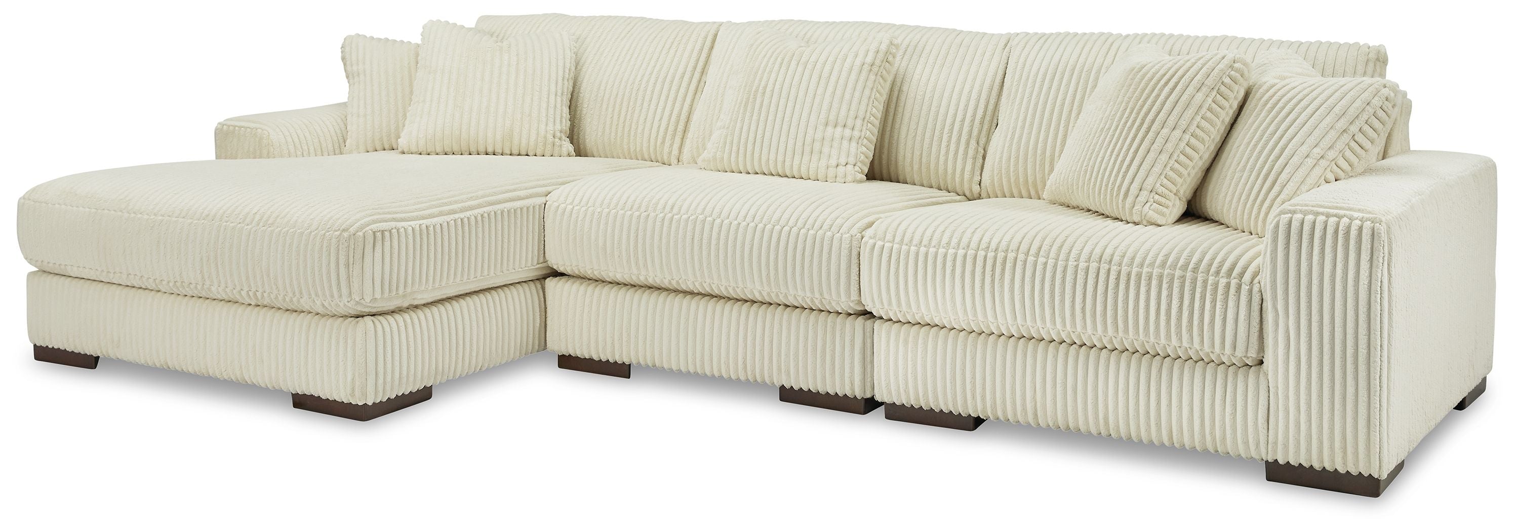 Ivory sectional sofa with chaise and stacked seat cushions, ribbed fabric upholstery.