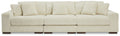 Ivory sectional sofa with three back cushions, track arms, and ribbed upholstery.