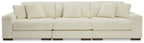 Ivory sectional sofa with three back cushions, track arms, and ribbed upholstery.